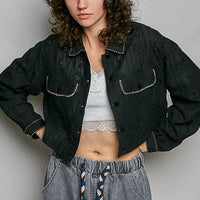 Black cropped button-front eyelet cotton jacket with pointed collar and front patch pockets.
