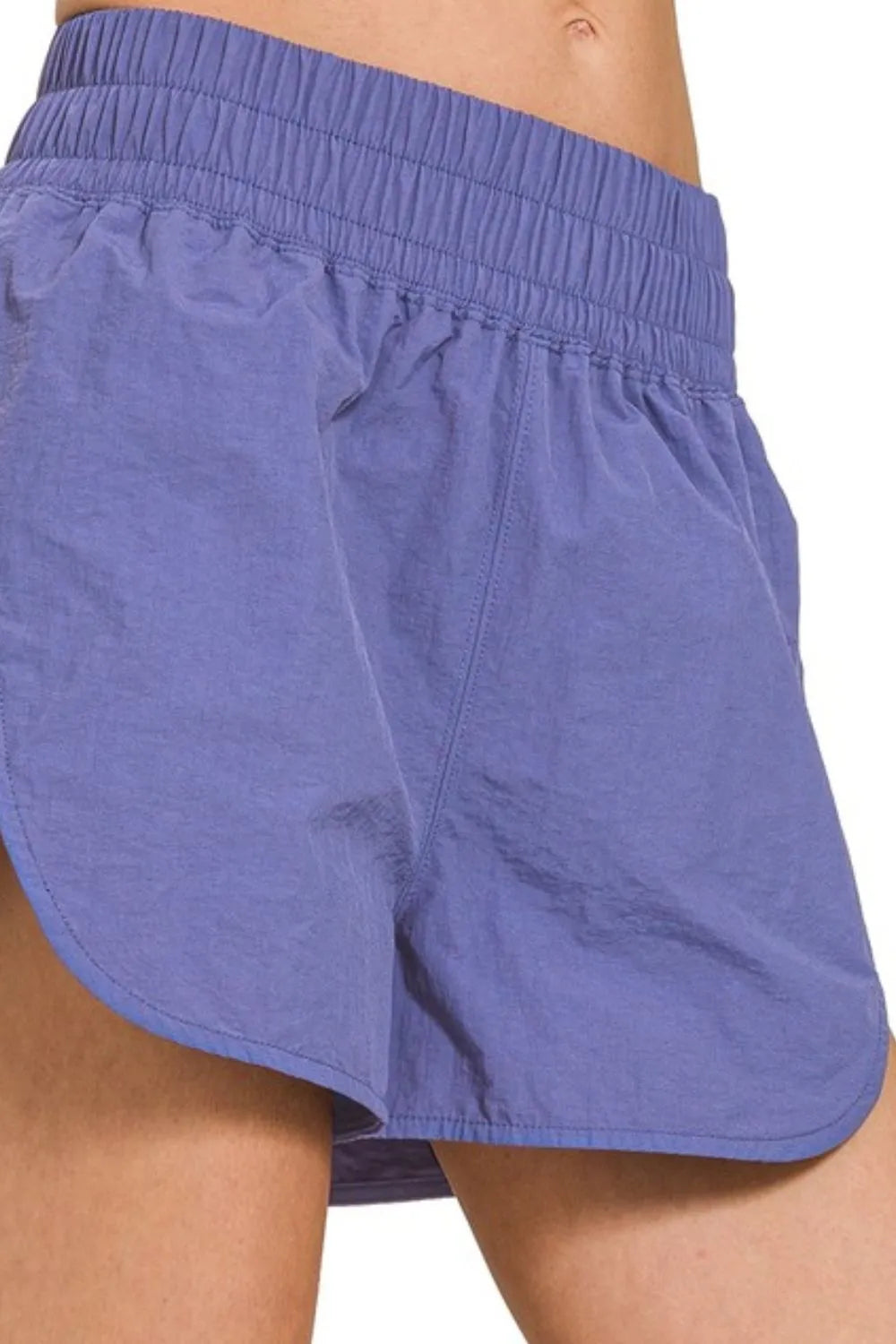Light blue windbreaker running shorts with gathered elastic waistband, back view