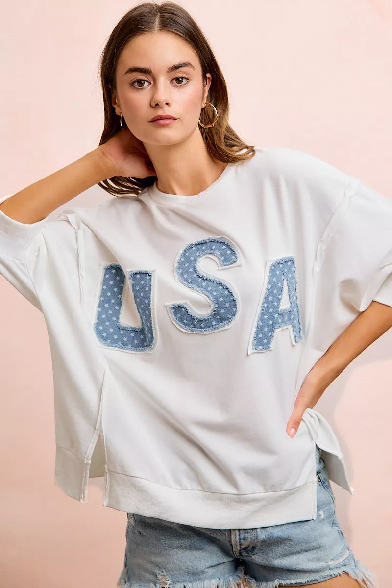 Ivory french terry top with blue "USA" letter applique, drop shoulder silhouette