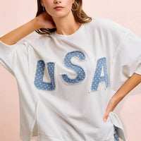 Ivory french terry top with blue "USA" letter applique, drop shoulder silhouette
