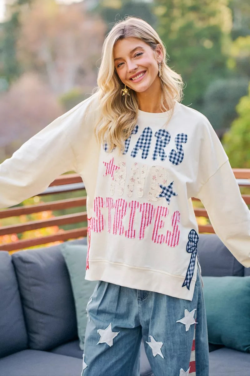 Cream sweatshirt with STAR-themed patch prints, red stripes, and blue stars