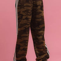 Camouflage track pants with elastic waistband, white side stripe, and cuffed hems.