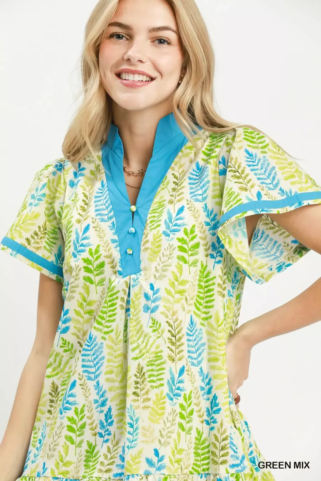Green and blue leaf print V-neck mini dress with button placket, close-up