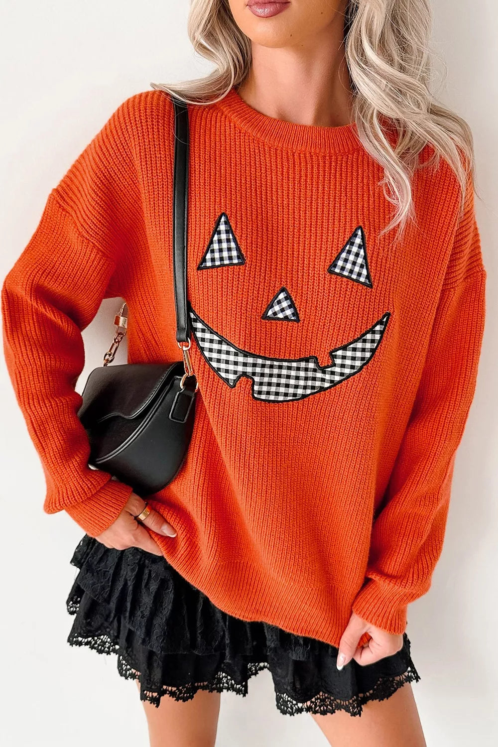 Orange knit sweater with jack-o-lantern graphic, drop-shoulder long sleeves