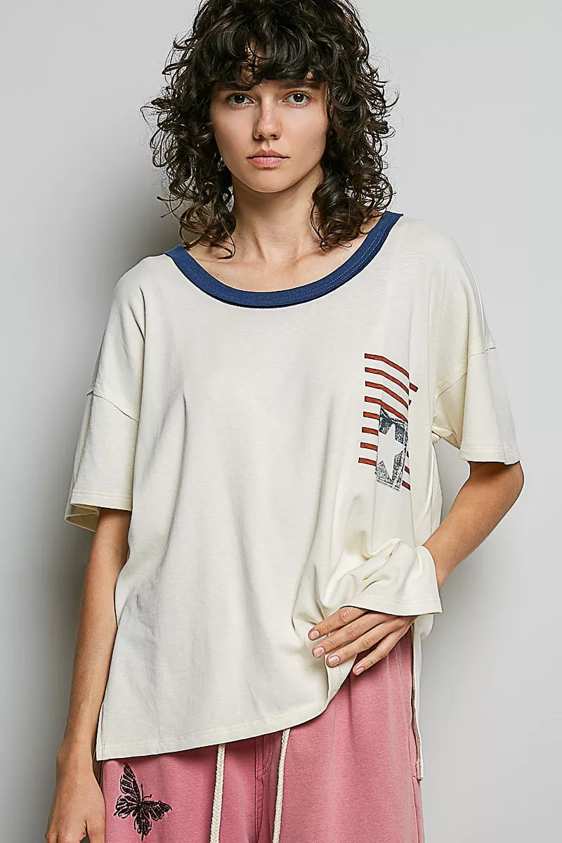 Cream cotton top with blue crew neckline trim and American flag graphic on chest