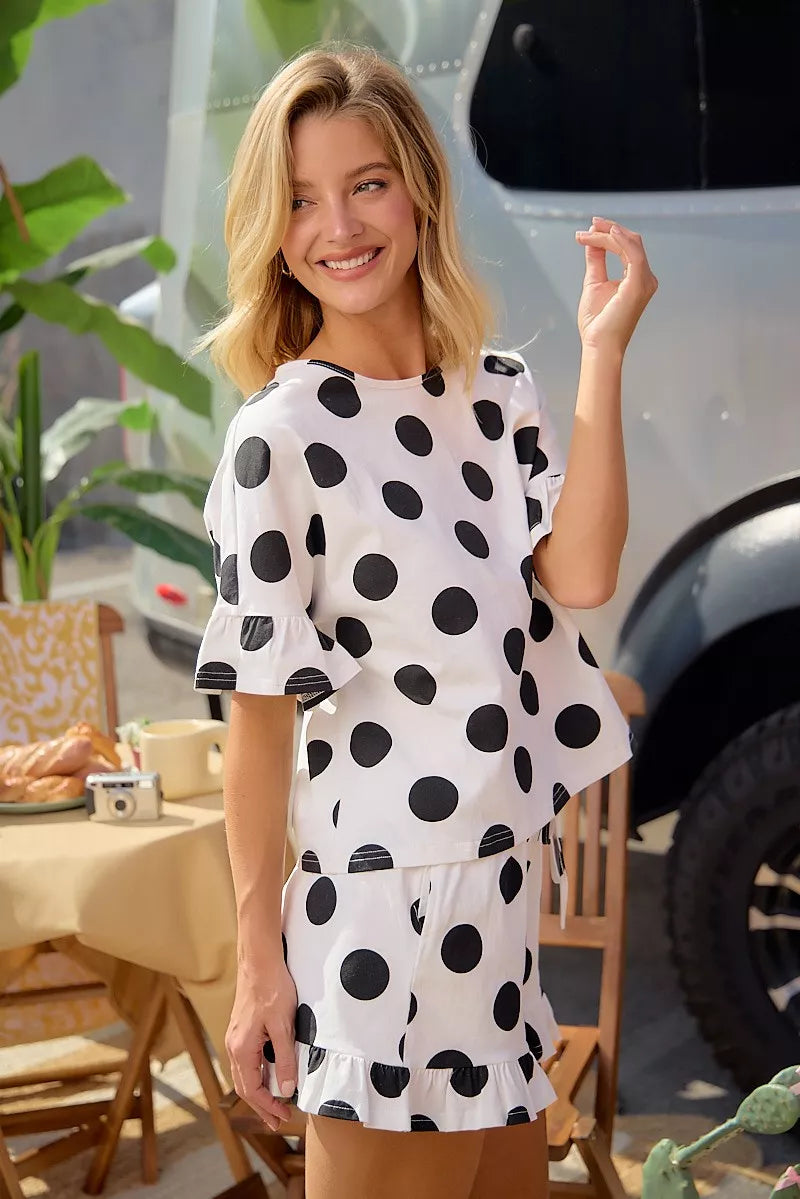 Ivory-and-black polka dot top and shorts set with ruffled hem detail