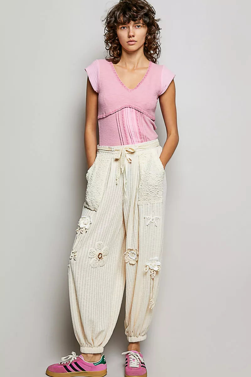 Soft pink V-neck lightweight textured knit top with lace trim and short sleeves