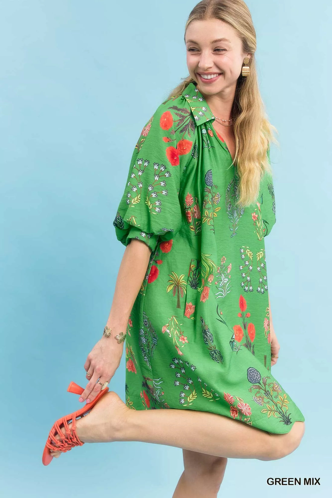 Green floral mini dress with V-neck and puff sleeves, side view with knee-length hem