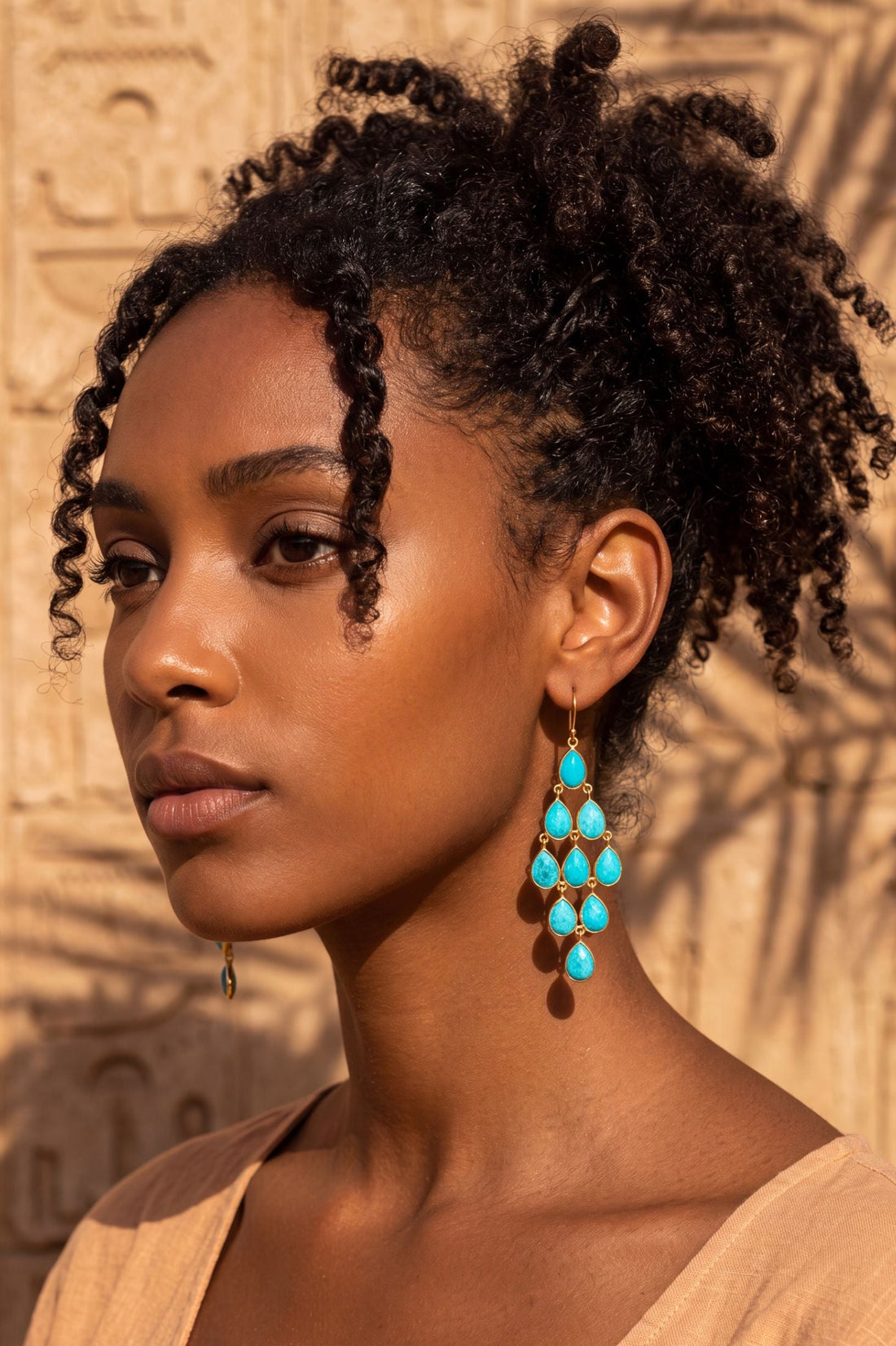 Turquoise gemstone drop chandelier earrings with silver settings, profile view