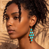 Turquoise gemstone drop chandelier earrings with silver settings, profile view