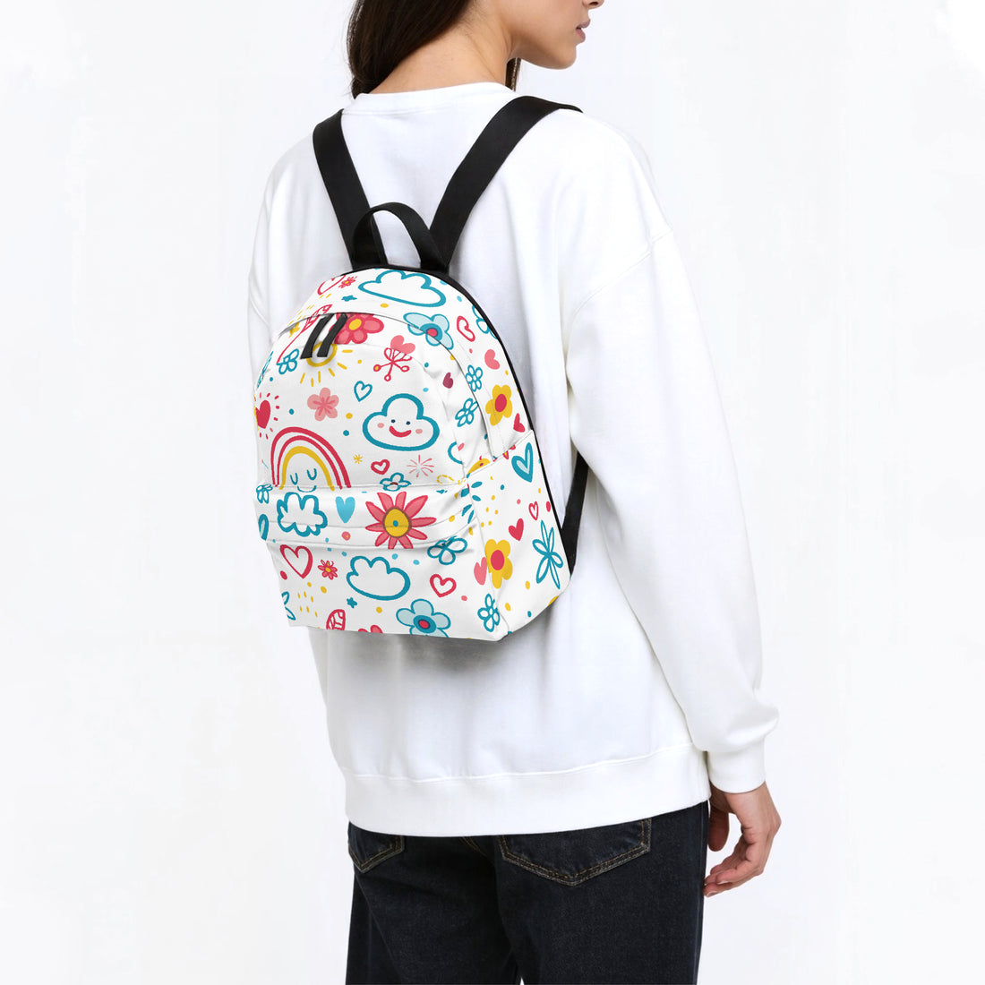 Kids small backpack worn on back: white canvas with colorful doodle rainbow print and black straps