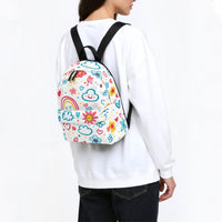 Kids small backpack worn on back: white canvas with colorful doodle rainbow print and black straps