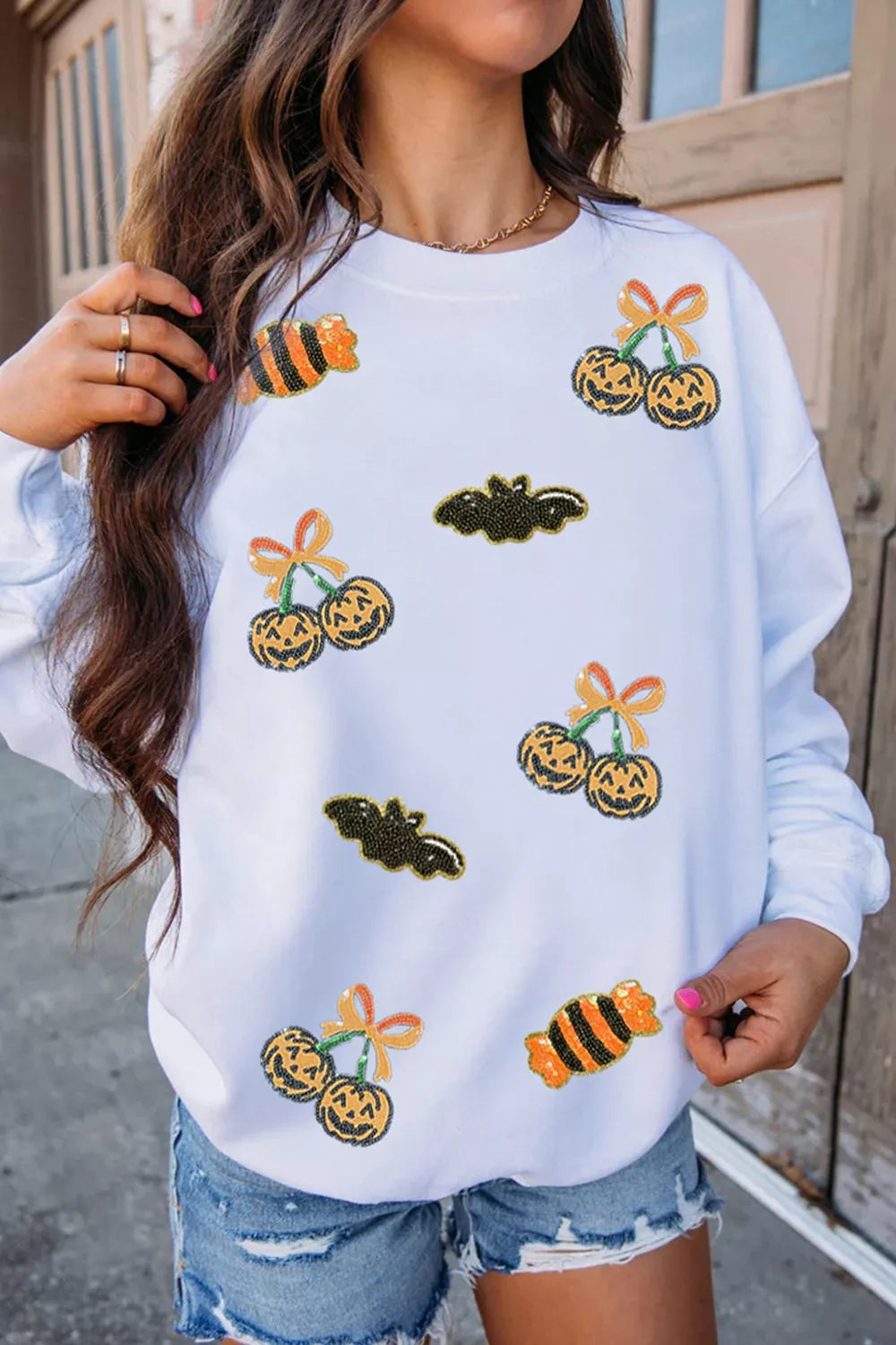 White sequin pullover sweatshirt with jack-o&