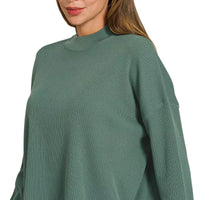 Teal-green crew-neck sweater top with long sleeves and textured knit