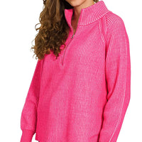 Hot pink ribbed half-zip sweater with contrast collar and long sleeves