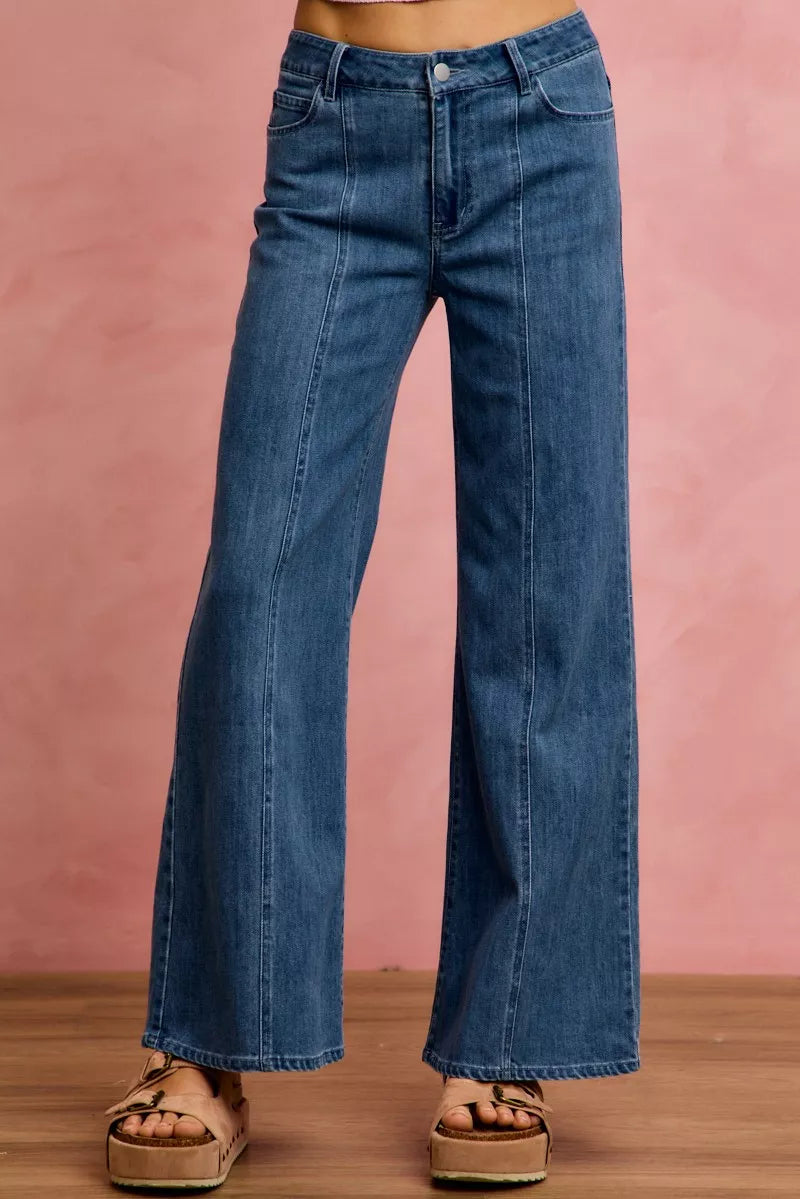 Mid-rise stretch denim jeans, front view showing center seam and flared hem