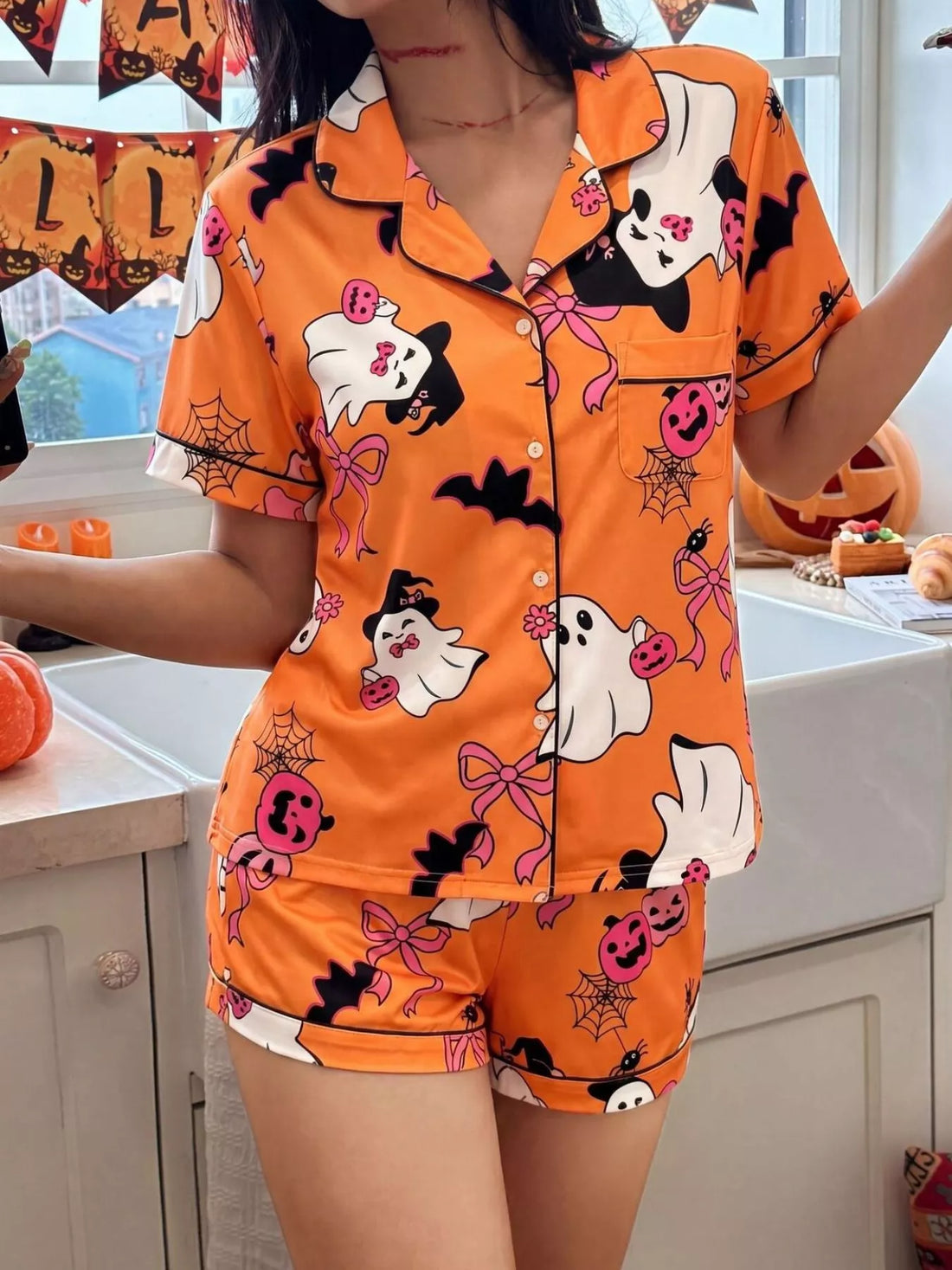 Orange Halloween lounge set with button-down short-sleeve top and matching shorts