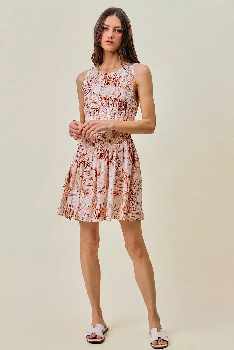 Coral and white shell-print mini dress with smocked waist, fit-and-flare silhouette