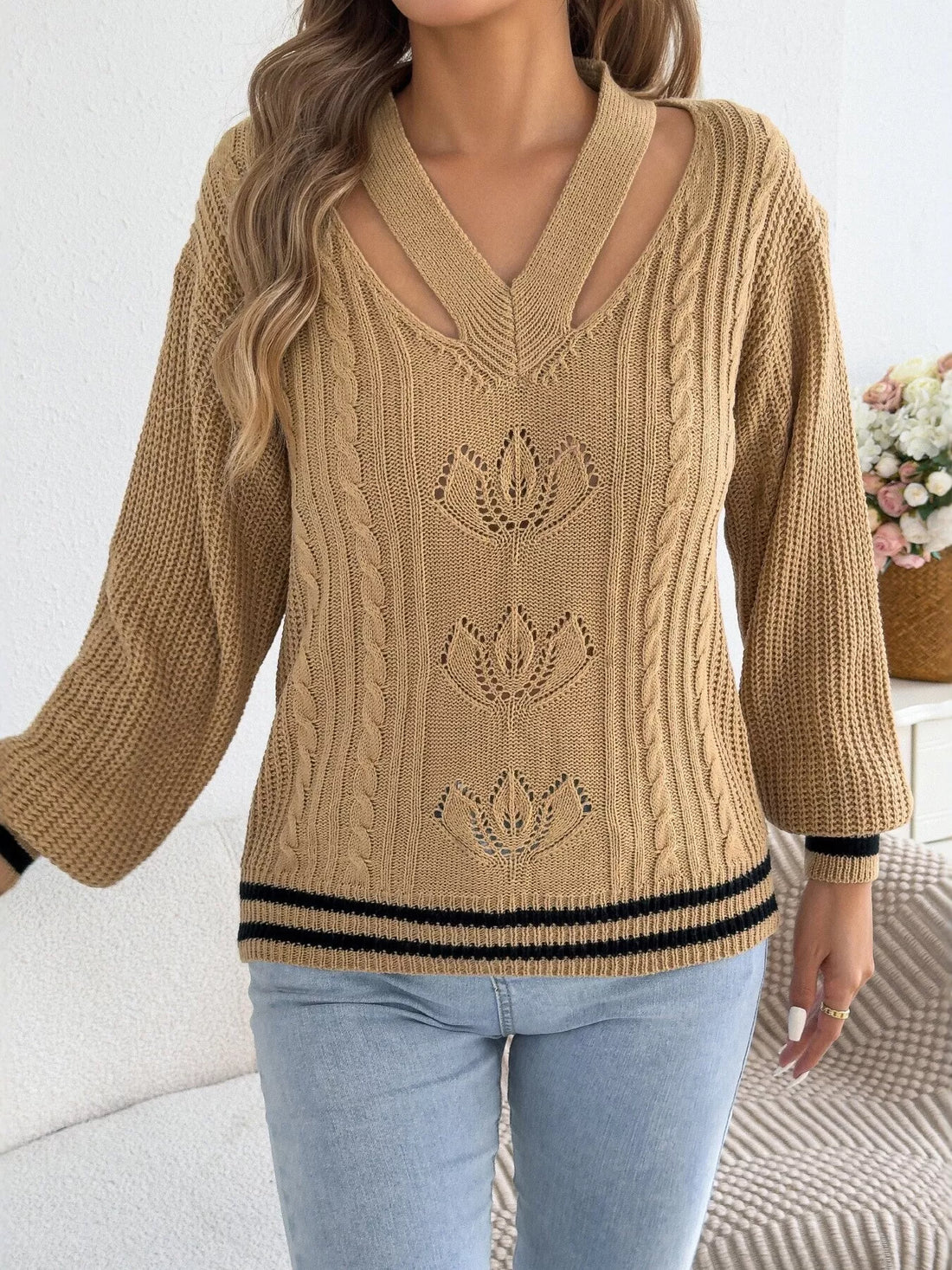 Camel V-neck cutout cable knit sweater with knit floral motifs and striped hem