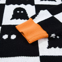 Black ghost checkerboard sweater with orange knit cuff detail