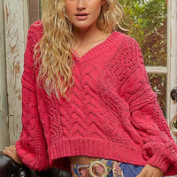 Fuchsia cable-knit cropped V-neck sweater with long sleeves and ribbed hem