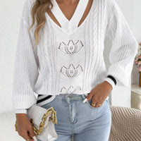 White cutout cable knit sweater with V-neck cutout, cable knit texture, and lotus motifs