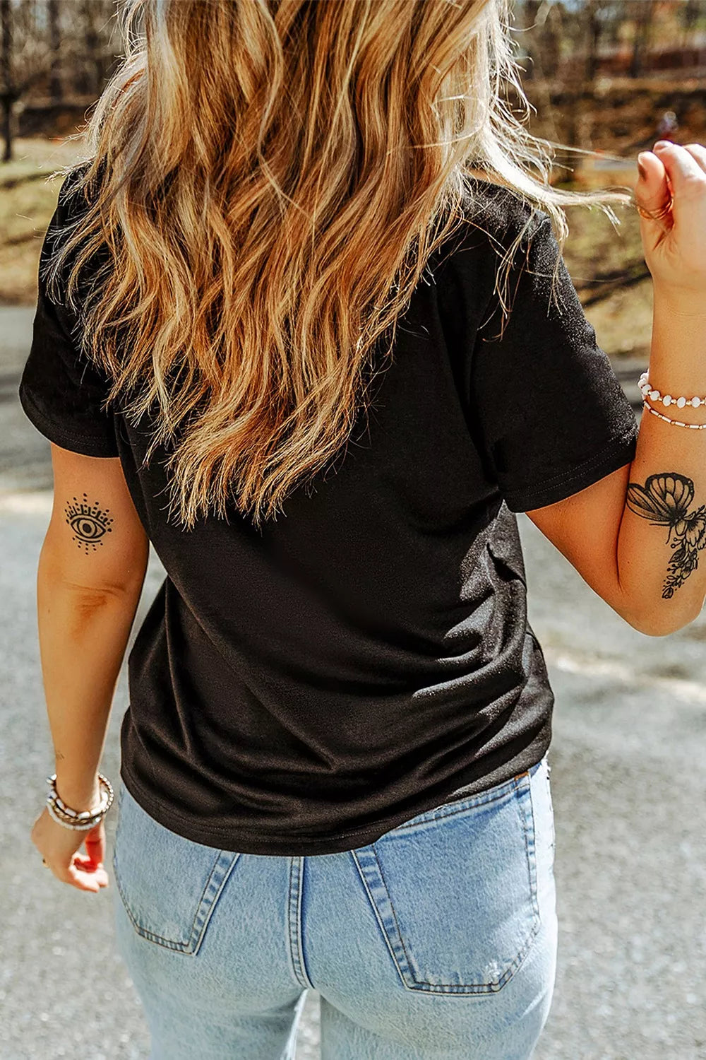 Black short-sleeve T-shirt back view, rhinestone ghost graphic on front