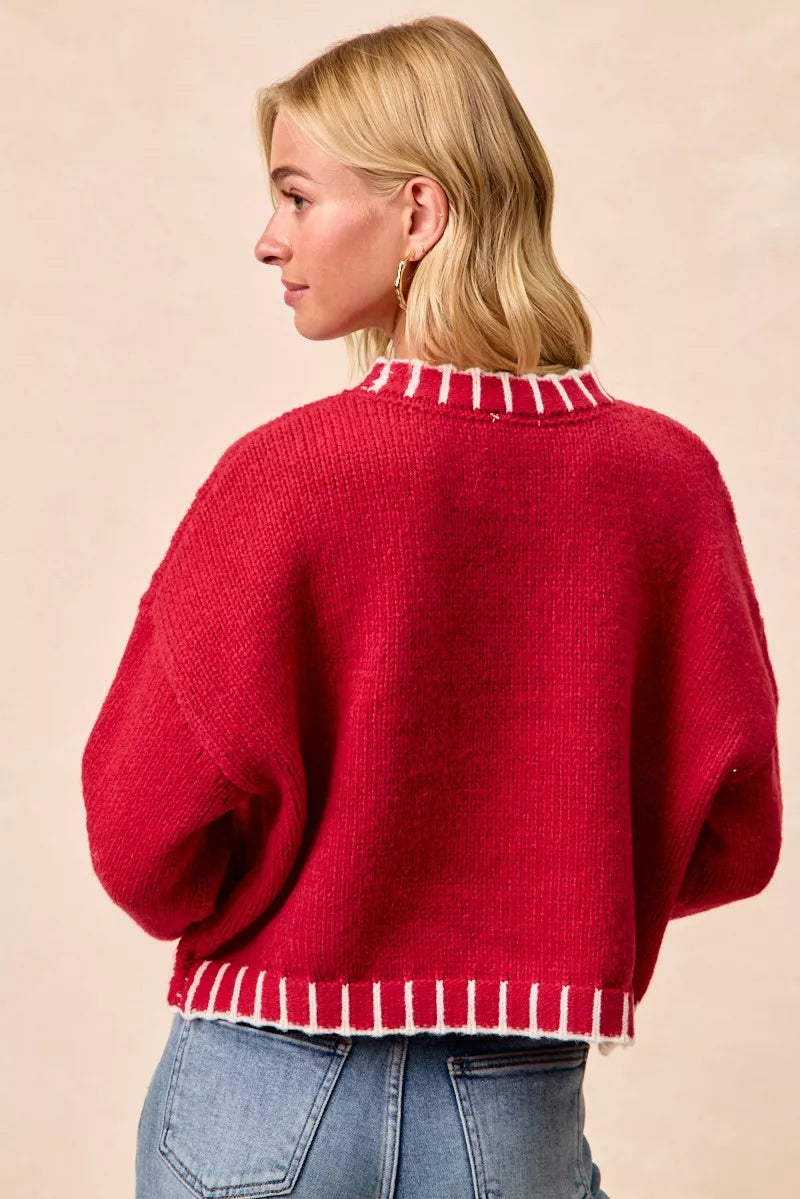 Red knit Christmas sweater, back view with ribbed hem and balloon sleeves.