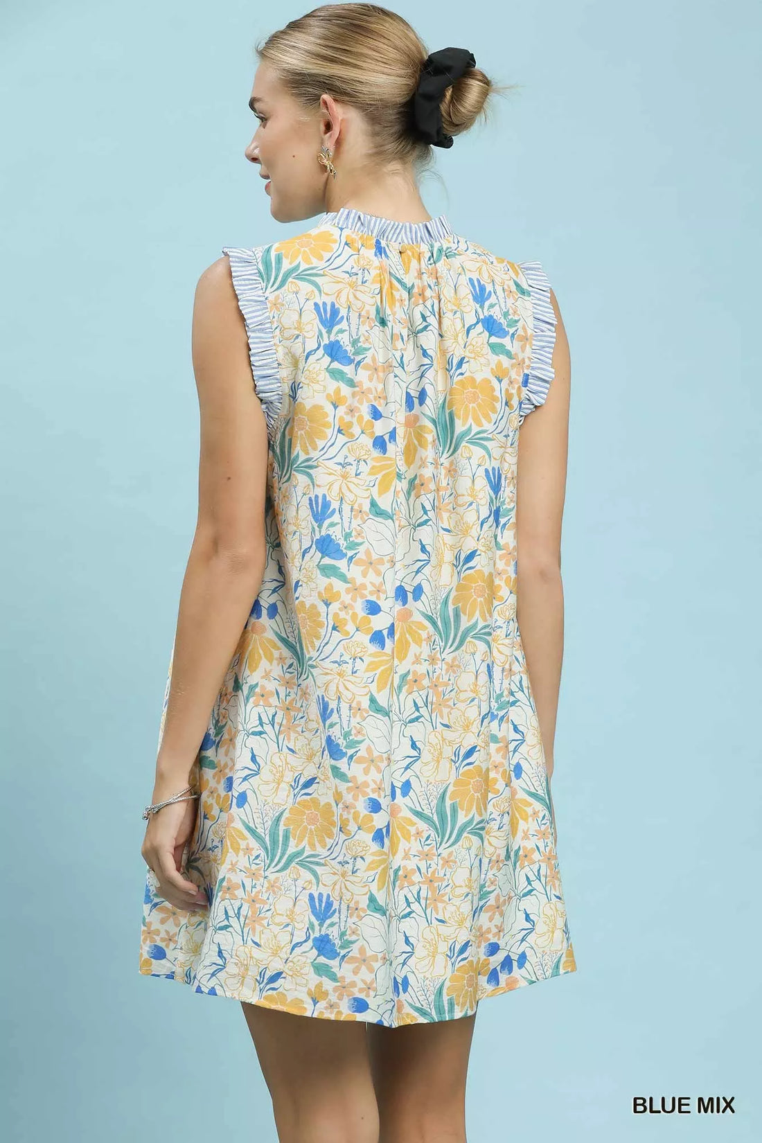 Floral babydoll dress, sleeveless back view with high ruffled neck, blue-yellow print