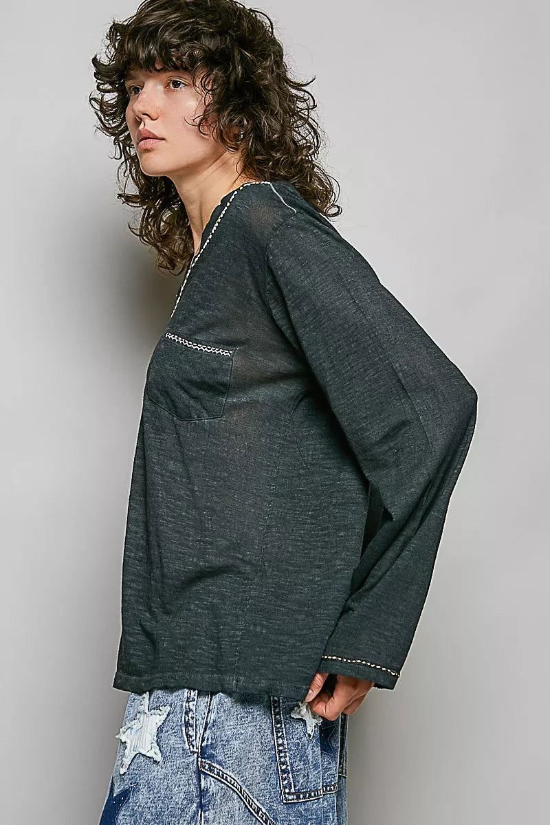 Dark green lightweight knit V-neck long sleeve top with contrast trim, side view