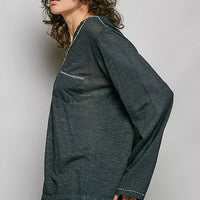 Dark green lightweight knit V-neck long sleeve top with contrast trim, side view