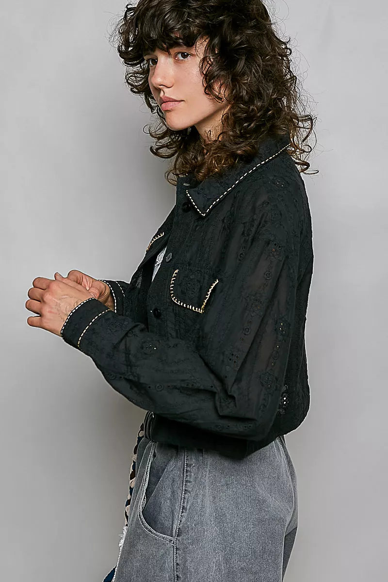 Black cropped eyelet cotton jacket, button-front, with curved stitched flap pockets and sleeves.