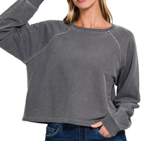 Dark gray round-neck pullover with long sleeves, close-up
