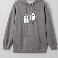 Dark gray oversize pullover hoodie with ghost face graphic on chest, drawstring hood