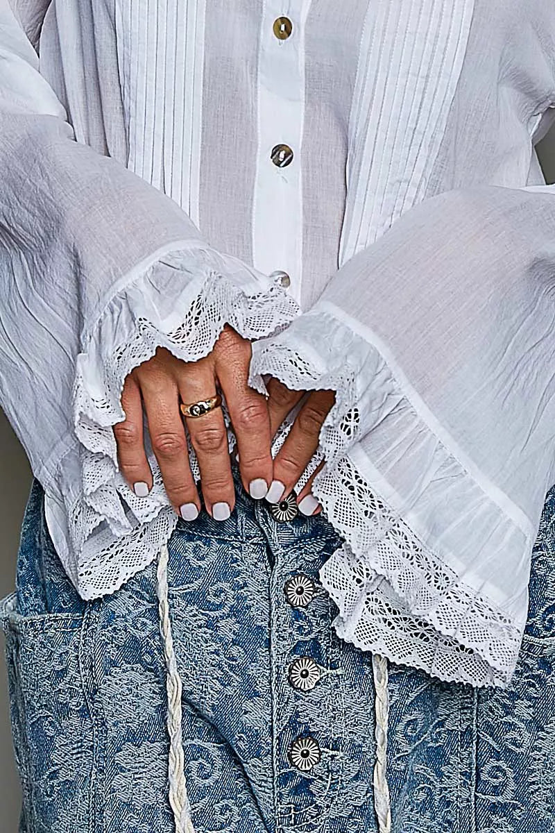 Ivory button-down shirt with lace-trim cuffs and pintuck placket over waistband
