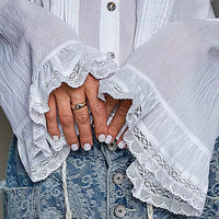 Ivory button-down shirt with lace-trim cuffs and pintuck placket over waistband