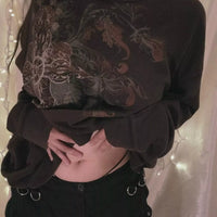 Black long sleeve t-shirt with large ornate skull graphic on front