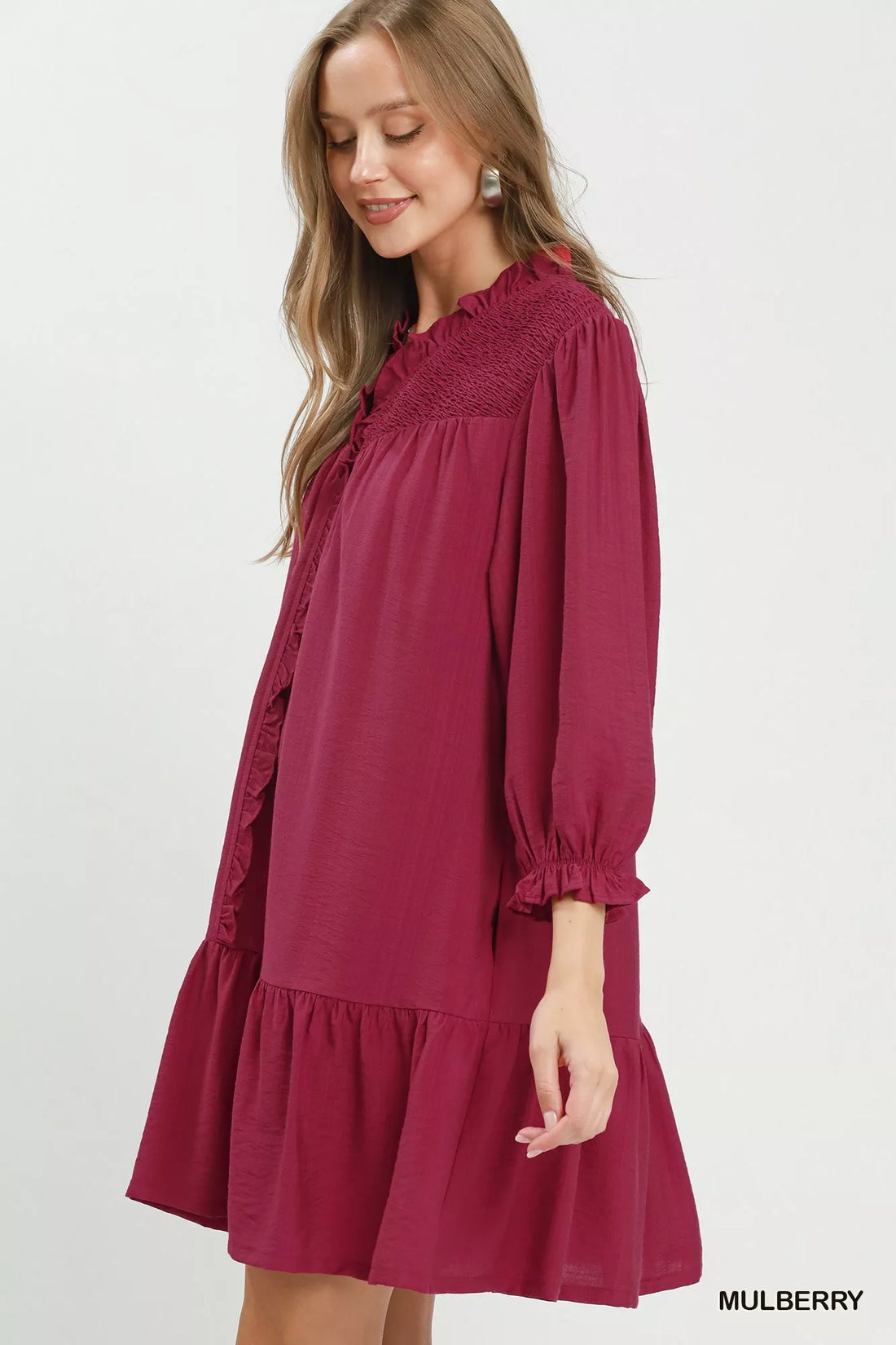 Mulberry mini dress side view with smocked ruffle V-neck, tiered hem, puff sleeves