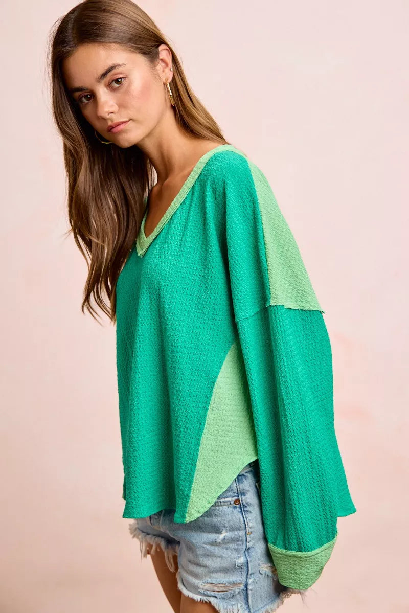 Textured jersey color block top with long sleeves, emerald green and light green contrast cuffs