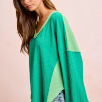 Textured jersey color block top with long sleeves, emerald green and light green contrast cuffs