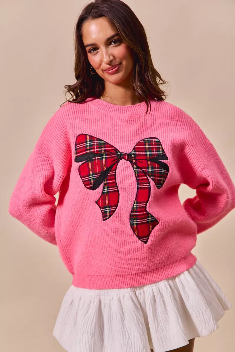 Pink crewneck sweater with plaid plaid-pattern ribbon bow at chest