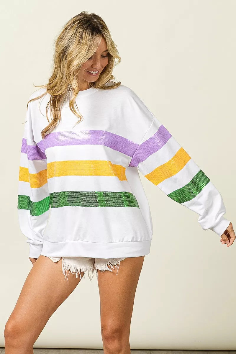 White sweatshirt with sequin-striped horizontal bands and long sleeves, side view