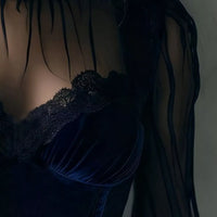 Navy velvet blouse bodice with lace trim and sheer sleeves, close-up view