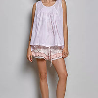 Lavender sleeveless cotton top with round neck, pleated front, and loose fit
