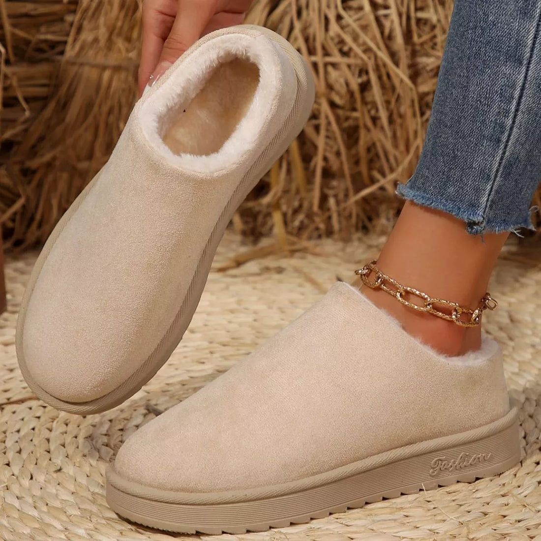 Off-white plush lined ankle boots with round toe, suede upper, slip-on style.