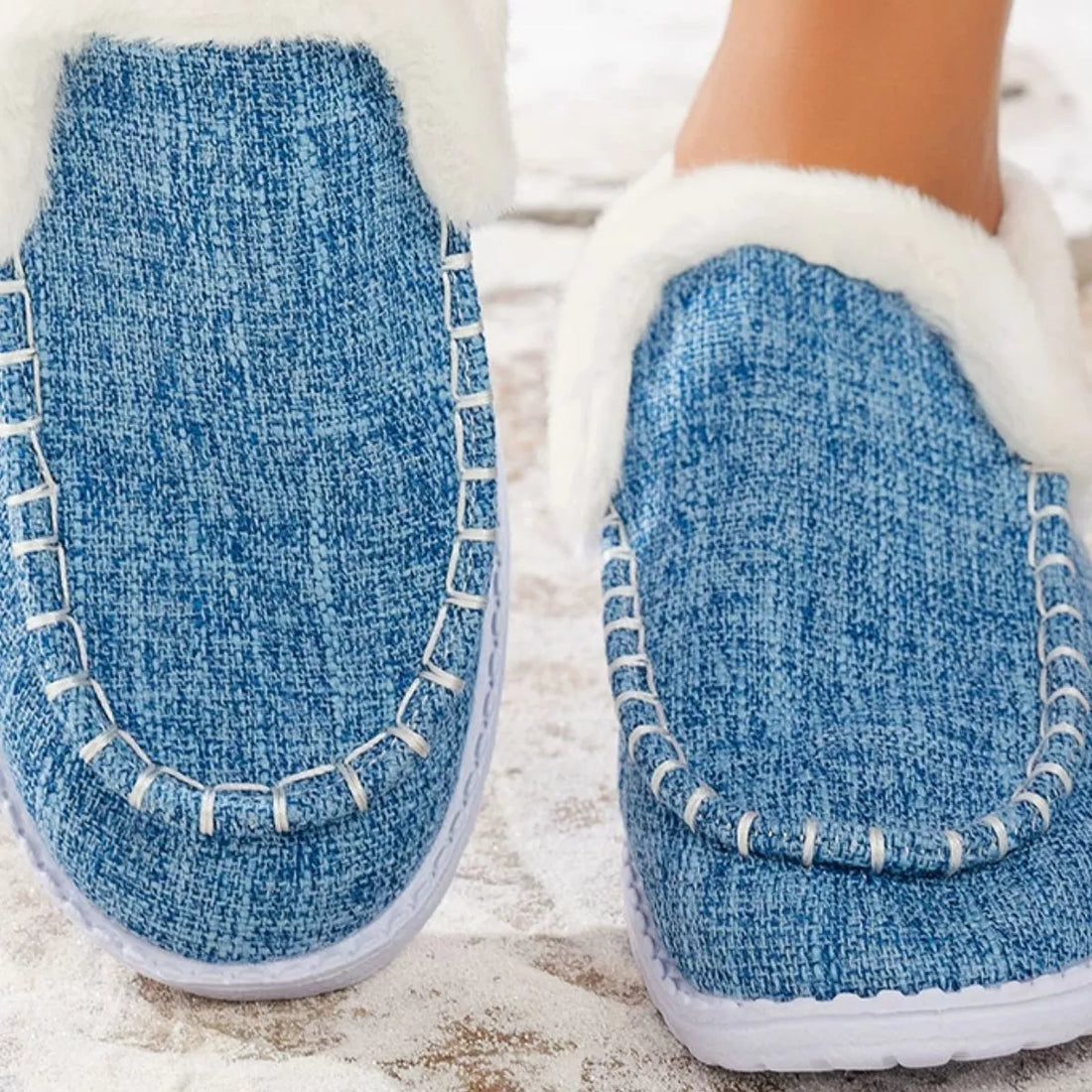 Light blue faux fur lined round toe slip-on shoes, side view with white trim
