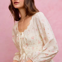 White floral clip-dot lace-trim blouse with ruched bodice, long balloon sleeves, and tie detail