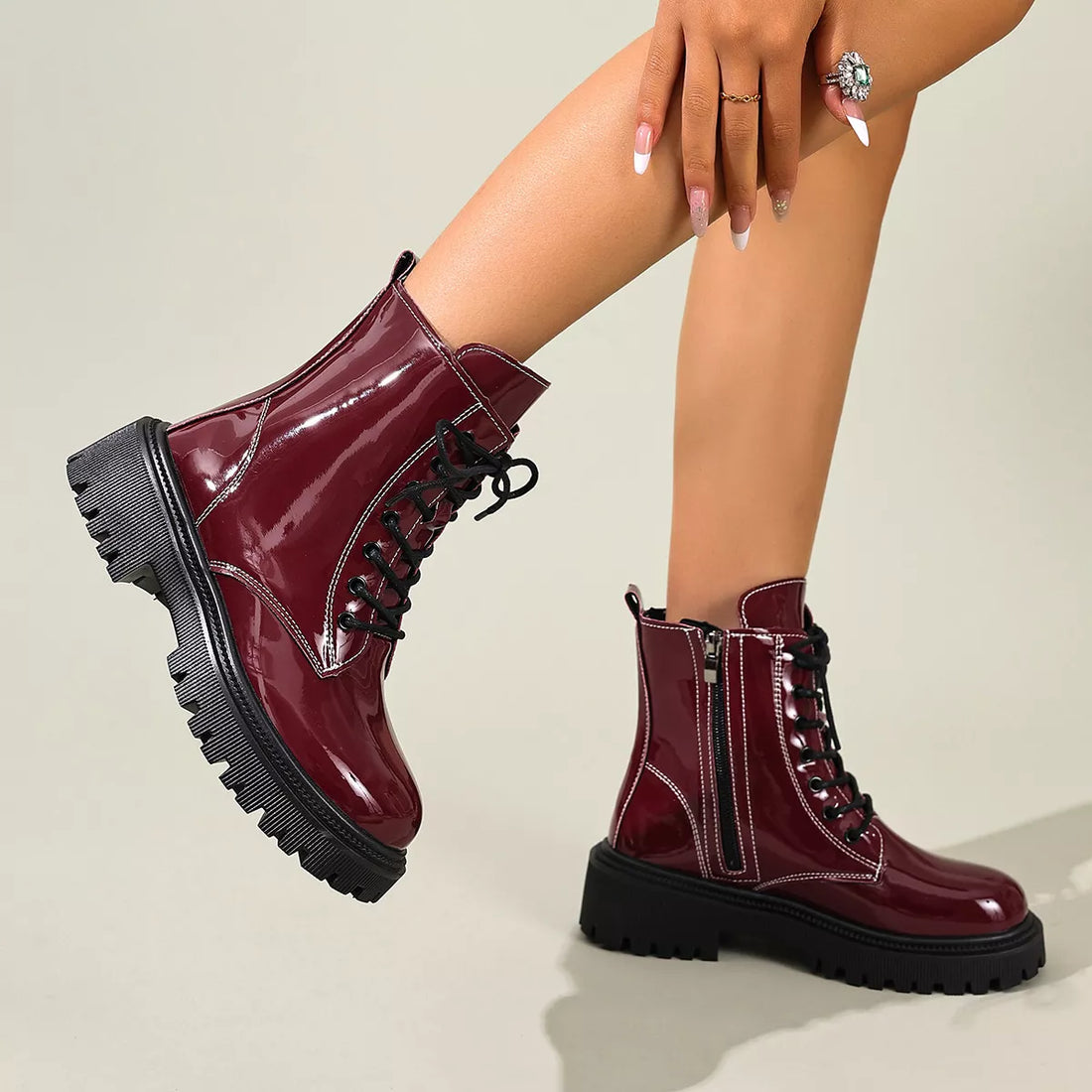 Burgundy lace-up block heel boots with side zipper, patent shine, and chunky tread