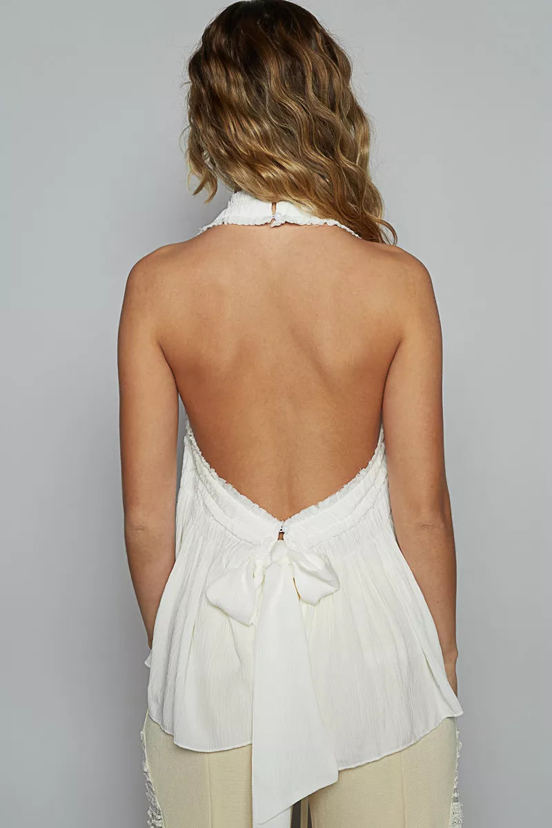 Backless off-white halter top with tie bow at back and shirred bodice