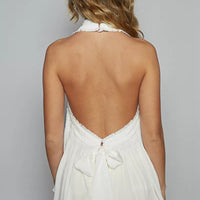 Backless off-white halter top with tie bow at back and shirred bodice